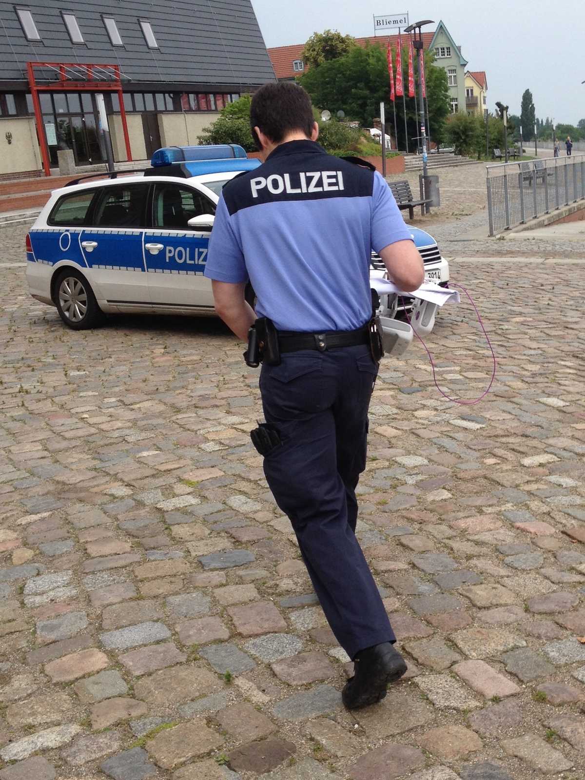 German police officers taking the controller to their car